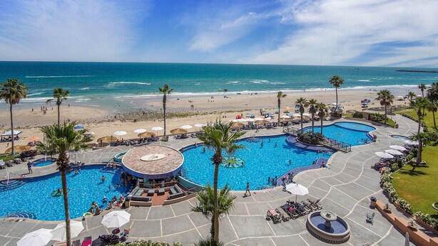 A resort with multiple swimming pools, a beach, and palm trees. - Outstanding Oceanfront unit with a Breathtaking View - Sonoran Sun E-511 (Puerto Peñasco)