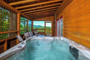 A hot tub in a wooden cabin with a view of the mountains. - Log cabin with pool table & hot tub-sleeps 8! (Pigeon Forge)