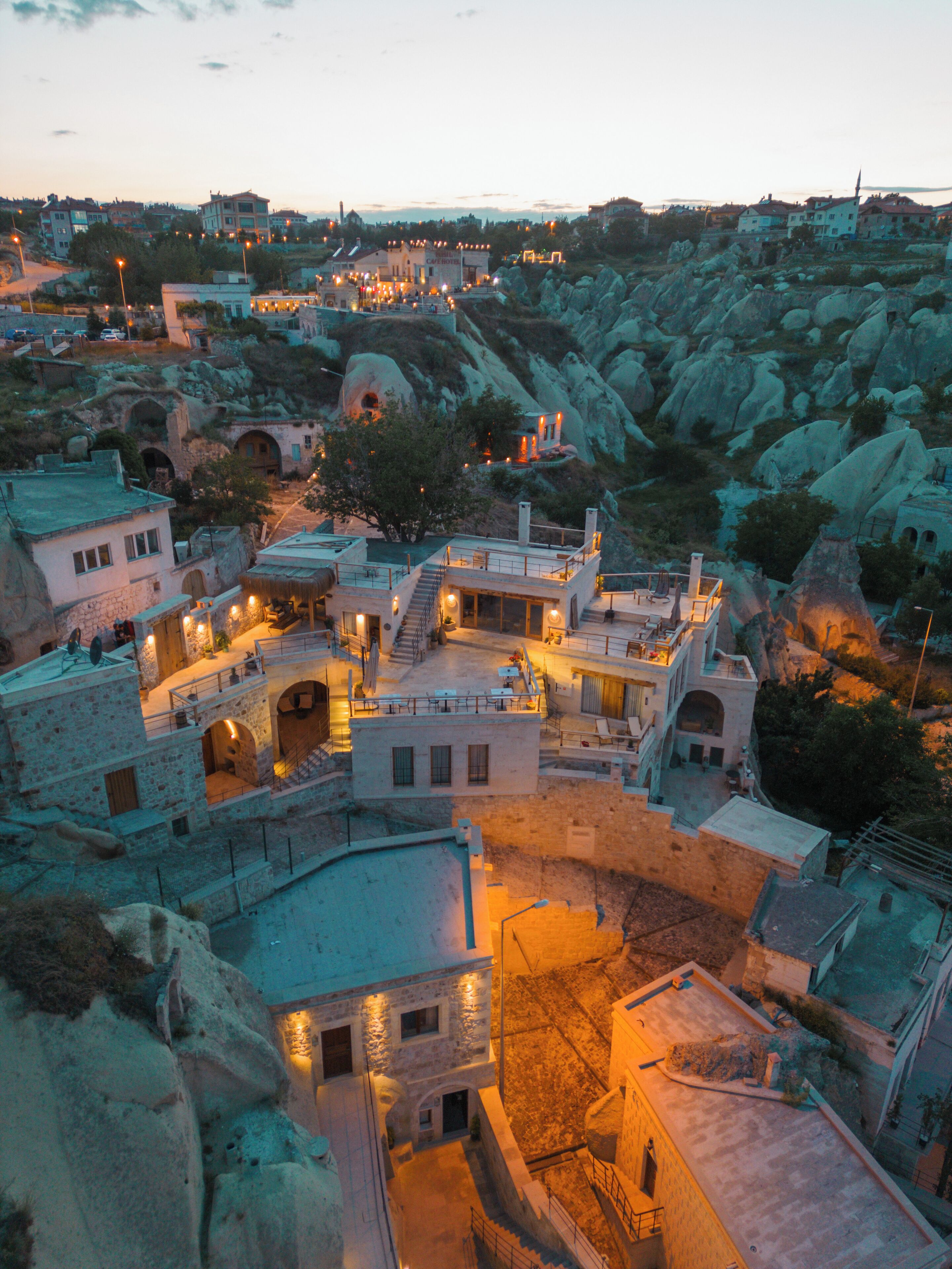 A mountainous town with stone buildings and a central courtyard.