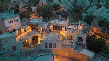 A mountainous town with stone buildings and a central courtyard.