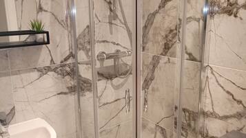 Shower, towels, soap, toilet paper