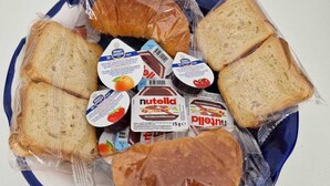 A plate with various packaged food items including bread, Nutella, and other spreads. - B&B Acquamarine (Salerno)