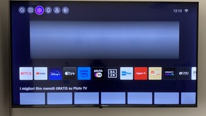 A flat-screen TV mounted on a wall with a remote control on a stand below it. - 2 Bedroom Apartment in Realmonte (Realmonte)