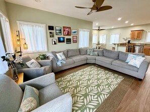 A living room with a sectional sofa, a coffee table, and a patterned rug. - "Hina Hideaway", Views, A/C, Walkable to Beach (Punaluu)
