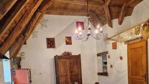 A rustic kitchen with a wooden ceiling, a dining table with chairs, and a red refrigerator. - Le Puy D'aubrac, Maison Familiale en Pleine Campagne (Florentin-la-Capelle)