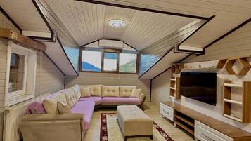 Deluxe Penthouse | Living room | 120-inch Smart TV with satellite channels, TV, heated floors