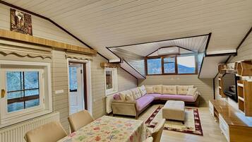 Deluxe Penthouse | Living area | 120-inch Smart TV with satellite channels, TV, heated floors