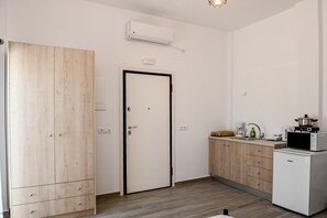 Modern kitchen with cabinet, sink, and appliances.