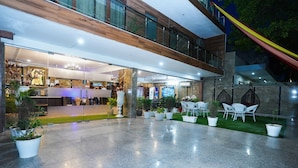 A modern hotel lobby with a spacious open area, seating arrangements, and a staircase leading to an upper level. - Fabhotel Tanvi Premium (Gurugram)