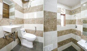 Un baño con inodoro, lavamanos y ducha.