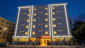 A modern hotel with a flat facade, multiple balconies, and a prominent 'Fabexpress' sign at the entrance. - FabHotel Broholic Suites I (Hyderabad)