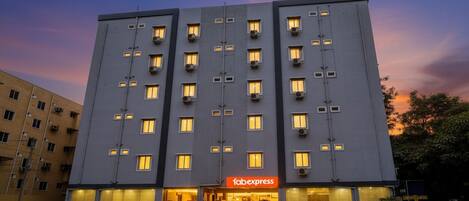 A multi-story hotel with a flat facade, multiple balconies, and a prominent 'Tabexpress' sign at the entrance.