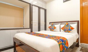 A hotel room with a bed, a window, and a wardrobe. - FabHotel SR Hitech City (Hyderabad)