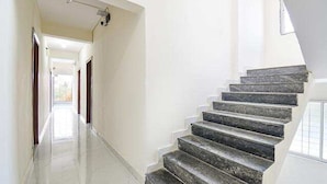 A staircase with a modern design, leading to an upper floor. - FabHotel Silver 9 (Paud)