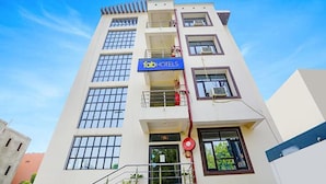 A multi-story hotel with a sign reading "fabHOTELS" on the facade.