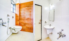 A bathroom with a toilet, sink, and shower. - Fabhotel Sai Govind (Rahata)