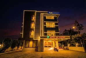 Un hotel moderno con un cartel que dice "fabHOTELS" y "HOTEL SAI GOVIND".
