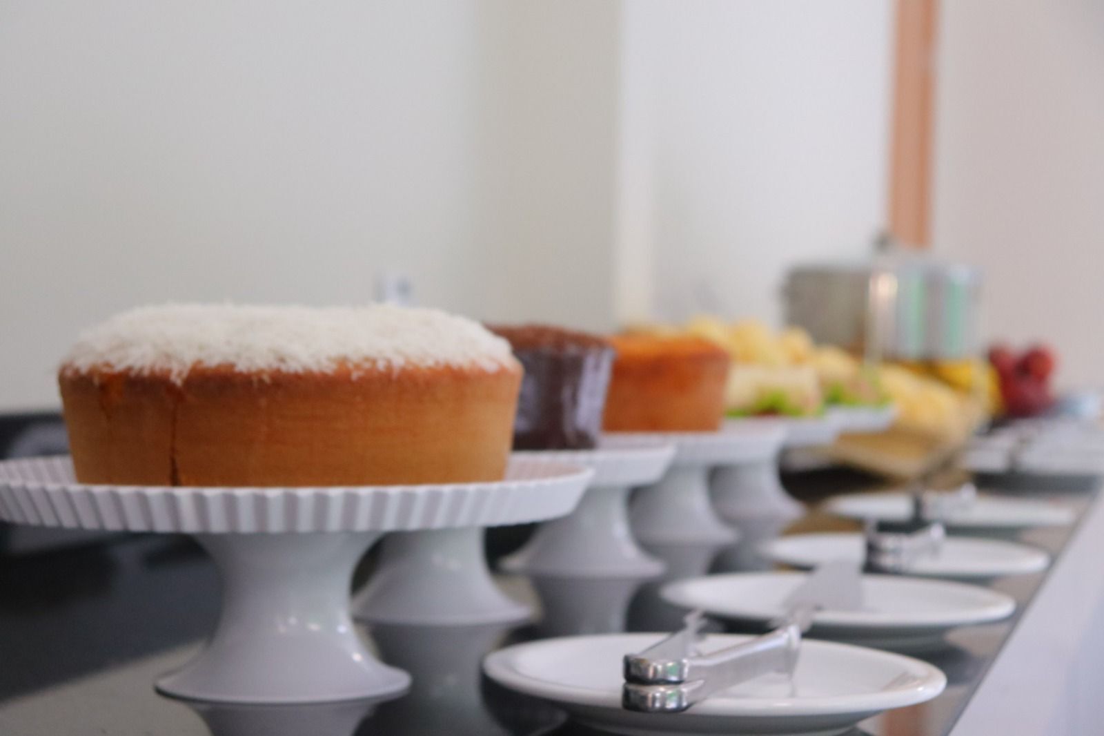 A buffet table with various baked goods and a fruit display.