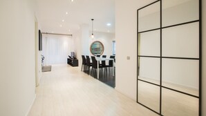 A modern interior with a dining area, a kitchen, and a large sliding door. - Valencia Luxury - Boutique Center (Valencia)
