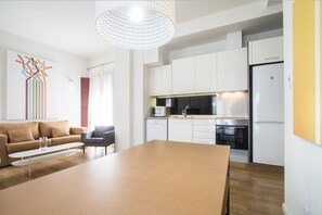 Deluxe Apartment, 2 Bedrooms (R-13) | Living area | 32-inch flat-screen TV with cable channels