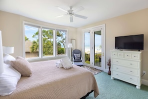 A bedroom with a bed, a television, a chair, and a dresser. - 34 Surf Scoter at The Sea Pines Resort (Hilton Head Island)