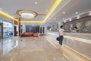 A hotel lobby with a reception desk, a seating area, and a large chandelier. - Victoria International Hotel (Kaiping Passenger Transport Terminal & Yihua Plaza Branch, Jiangmen) (Kaiping)