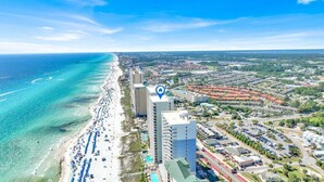 An aerial view of a coastal city with a beach, high-rise buildings, and a clear blue sky. - Ocean Ritz 2 Primary Suites | Expansive Balcony | Sleeps 12 (Panama City Beach)