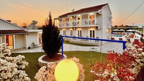 A two-story building with balconies, a swimming pool, and a well-maintained garden. - Sidari Beach Villa with private pool (Sidari)