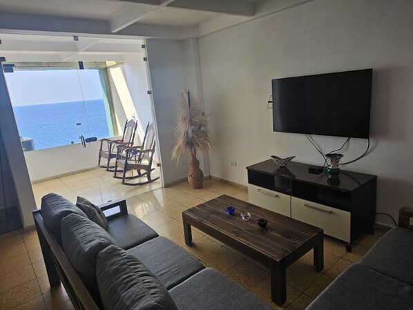Deluxe Apartment, 2 Bedrooms, Balcony, Sea View | Living room | 50-inch Smart TV with digital channels, TV