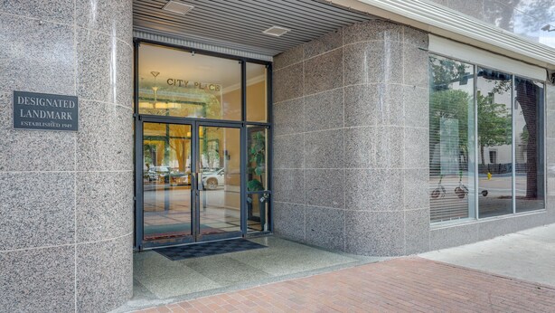 A building entrance with a sign indicating it is a designated landmark. - Downtown Jacksonville Studio w/ City Views! (Jacksonville)