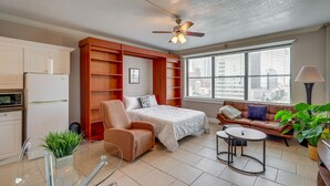 A compact living space with a kitchenette, a bed, a sofa, and a dining area. - Downtown Jacksonville Studio w/ City Views! (Jacksonville)