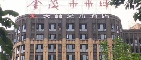 A multi-story building with a prominent sign at the top.