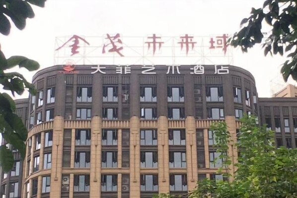 A multi-story building with a prominent sign at the top.