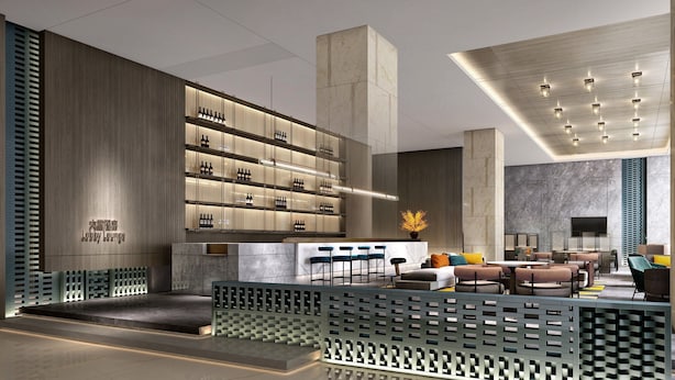 A modern lobby with a bar area, seating, and a decorative plant. - Crowne Plaza Dujiangyan by IHG (Chengdu)