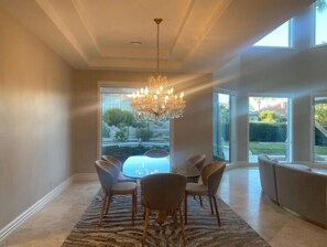 Enjoy meals at the large oval dining table surrounded by six chairs in this stylish space.