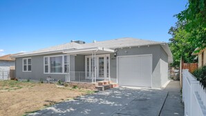 A single-story house with a garage, a covered porch, and a small front yard.