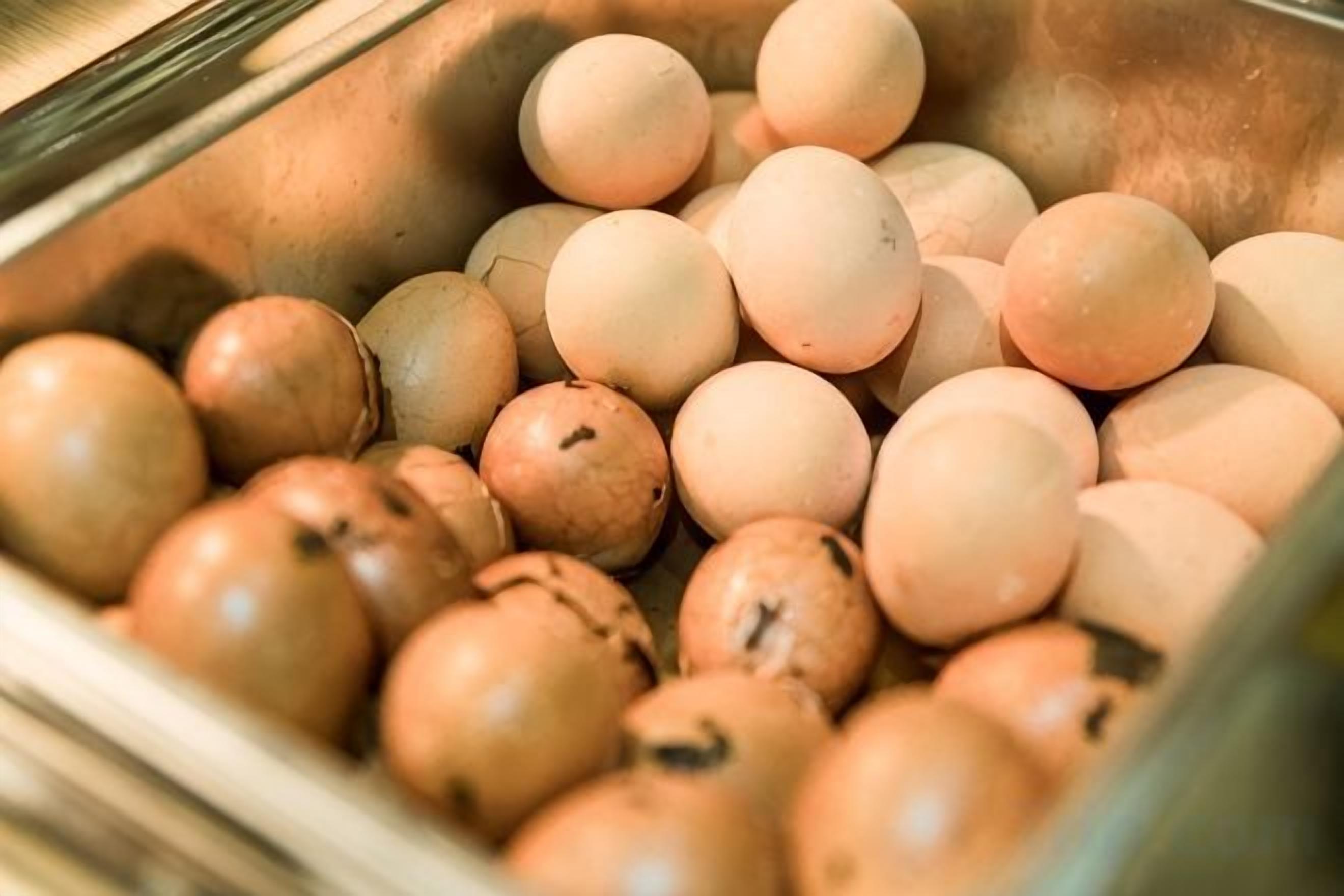 A stainless steel sink filled with eggs.