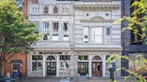 A building with a classic architectural style, featuring large windows and decorative elements. - Union Street Lofts (Nashville)