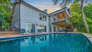A modern two-story house with a swimming pool, large windows, and a balcony. - Lakeshore Adrift (Denver)