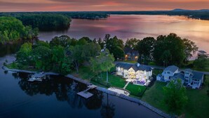 A lakeside property with a dock, a large house, and a smaller building. - Hogan Crest (Mooresville)