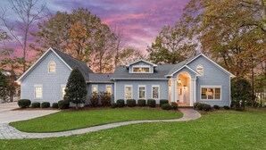 A two-story house with a front entrance, a covered porch, and a driveway. - Hillstone Ridge (Mooresville)