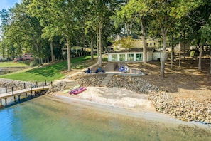 A lakeside property with a dock, kayaks, and a covered seating area. - Kempton Cove (Mooresville)