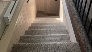 A wooden staircase with a handrail, a small window, and a sign indicating a food service area. - West Glacier Hot Tub! On Golf Course! Private Home (Flathead County)