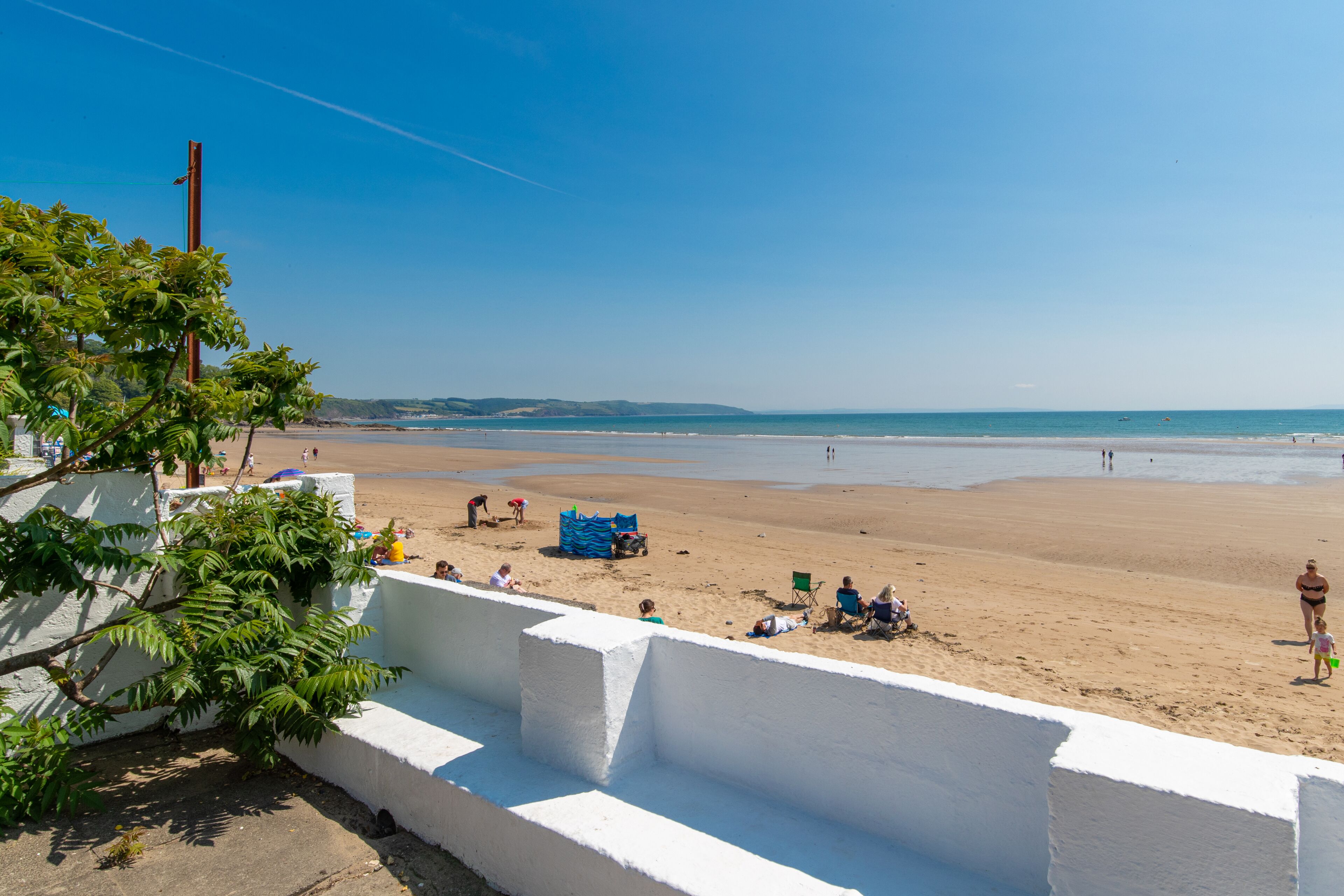 A beach with white walls and a clear blue sky.