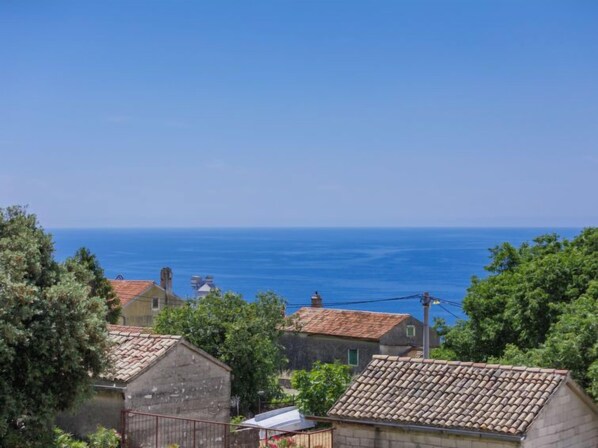 A coastal village with traditional stone buildings and a clear view of the sea.