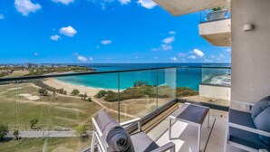 A balcony with a clear view of the beach and ocean. - A-1102 Spacious and modern two bedroom with oceanview (Cupecoy)
