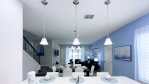 A modern kitchen with a central island, stainless steel sink, and pendant lighting. - Balmoral Resort-213al 3 Bedroom Home by RedAwning (Haines City)