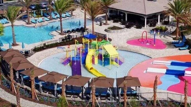 A resort with a swimming pool, water slides, and a playground. - Balmoral Resort-213al 3 Bedroom Home by RedAwning (Haines City)