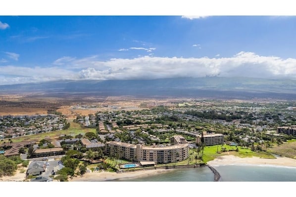 A coastal resort with multiple buildings, a beach, and a view of the distant landscape. - Menehune Shores, #210 3 Bedroom Condo by RedAwning (Kihei)