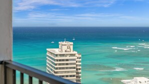 A high-rise hotel with a view of the ocean and boats. - Beach Oasis with Ocean & City Views with FREE Parking! (Honolulu)